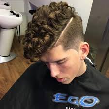 With this look, the bun is done on the top of the head, high. Good Haircuts For Teenage Guys With Curly Hair Folade