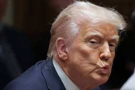 U.S. President Donald Trump listens to a reporter's question during an  Ambassador Meeting in the Cabinet Room of the White House in Washington,  DC. During the meeting, Trump answered questions from reporters