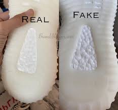 On real pairs of black yeezy boosts, the heel has a slight bump and dip whereas the replica pairs of yeezys don't have this. How To Spot Fake Adidas Yeezy Boost 350 V2 Zebra Brands Blogger