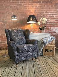 Elegant black background with faint sponged grunge texture border in an old vintage design, shiny silver gray color center in backdrop in motion blur effect. Black Grey Flower Pattern Armchair Supa Sofa Leeds