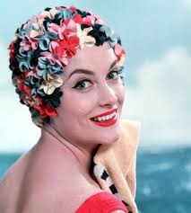 Models show the latest fashions in swimming hats including one made to look  like hair, London, 1963."