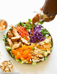 Sprinkle the blue diamond slivered almonds and sesame seeds over the salad; Light Chinese Chicken Salad Immaculate Bites