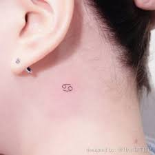 Cancer ribbon tattoos are often portrayed in colorful bows and designs, where the shade of the color signifies the type of cancer the tattoo is referring to. Zodiac Cancer Symbol Behind The Ear Tattoo Behind Ear Tattoos Cancer Zodiac Tattoo Cancer Tattoos