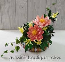An Arrangement Of Water Lilies Accompanied By Ylang Ylang Flowers Green Black Berries Chinese Yam Leaves In Sugar Ashwinisboutiquecakes