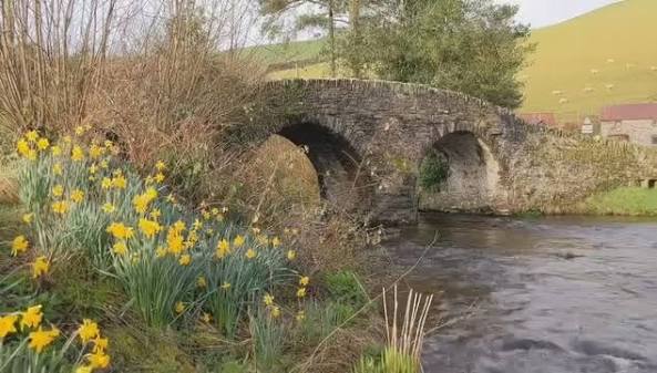 Malmsmead Bridge is a 17th-century stone bridge which crosses Badgworthy Water. Located in the Doone Valley on the border between Somerset and Devon, here's how it has looked over the last 100