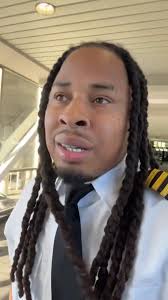 A Black pilot is facing backlash after sharing a video of himself with  dreadlocks and grills following a flight.🤔
