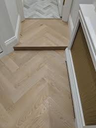 We Incorporated A Small Step In This This Chevron Floor To Allow For The Small Increase In The Floor Level Chevron Floor Wood Parquet Flooring Flooring