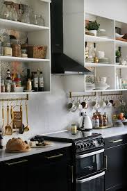 Black And Gold Kitchen Wallpaper That Stuns With Its Dark Cabinets Contrasting Copper Fixtures And Accent Wallpaper Modern Kitchen Design Kitchen Design Gold Kitchen