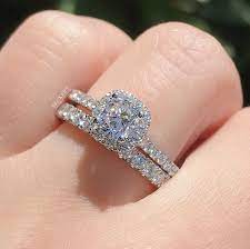 The Perfect Classic Bridal Look A Wedding Band Slightly Wider Than Your En Halo Engagement Ring Sets Classic Engagement Ring Set Engagement Rings Bridal Sets