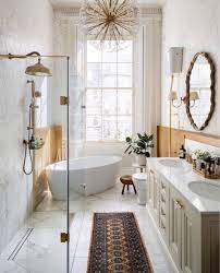 A refined neutral bathroom with a white tub, vanity and tiles, a wooden bench and blush curtains a serene neutral bathroom with hex and marble tiles, a marble vanity countertop, some blooms and a printed curtain a small neutral bathroom with a tile clad tub, copper fixtures and a hex tile wall for a chic look 9 Neutral Bathroom Ideas For A Fresh And Clean Look