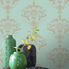 Several pastel color dyed easter eggs on duck egg blue in flat lay with copy space. Rasch Marlow Damask Duck Egg Gold Metallic Wallpaper 214826