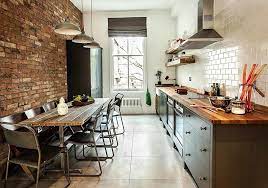 The stainless steel hood and exposed piping pop against the navy walls, while the striped blue fabric lightens the mood. 100 Awesome Industrial Kitchen Ideas