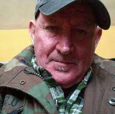 Why does a 70cc 2-stroke engine crank over fine without a spark plug but  experiences kickback when the plug is installed?