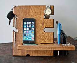 Not only is the docking station completely unique in its design, it is even made from the stumps of dead trees, the wooden oak charging dock has been carved out to create neat little niches for the electronic gadgets. Dark Wooden Stand Desk Accessories Wood Iphone Dock Apple Etsy Diy Phone Stand Diy Phone Wood Docking Station