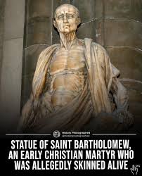 Saint Bartholomew, who was an early Christian is believed to have been skinned  alive for his faith. In the sculpture, he's not holding a robe; it's  actually his own skin. Created by