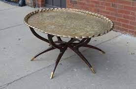 This tray is perfect for carrying coffee, tea, cocktails, and small snack items from room to room, and can also be used as a sleek vanity tray for displaying jewelry, trinkets, keepsakes, and other decorative items in your bathroom or on a coffee table or ottoman surface. Large Vintage Brass Tray Coffee Table On Midcentury Folding Base Brass Coffee Table Coffee Table Wood Tray Coffee Table