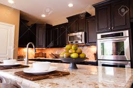Should i do light or dark wood floors with white cabinets? many people wonder whether they should do light or dark wood floors with white cabinets. Modern Kitchen With Dark Wood Cabinets And Hardwood Floors Stock Photo Picture And Royalty Free Image Image 15079363