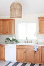 Tips And Tricks To Update Dated Oak Kitchen Cabinets Without Painting Them Make Your Oak Cabinets Feel Modern An Oak Kitchen Cabinets Oak Kitchen Oak Cabinets