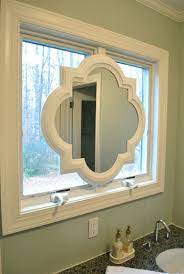Here is the mirror after i very lightly went over the the top of the textured frame with taupe paint on a foam brush i also like to spray paint mirrors to update them or change the colors. Painting Our Quatrefoil Mirror Over The Sink Young House Love