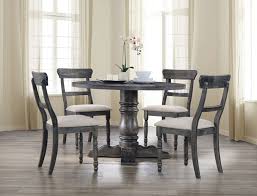 The table is paired with eight chairs based on wooden frames. 74640 42 5 Pc Leventis Weathered Gray Finish Wood 47 Round Dining Table Set