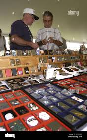 Fred Wenzel, a Zippo lighter dealer from Warren, Pa., left, waits to  inspect a lighter from Santo Pecra during the Zippo Lighter swap meet in  Bradford, Pa., Friday, July 21, 2006. Thousands
