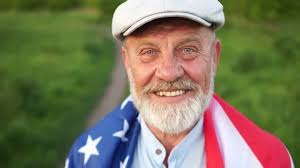 Close portrait of an American farmer with a flag
