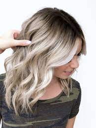 This warm color is beautiful on every skin tone and looks amazing on long slightly wavy hair. Hairstyle Trends 28 Blonde Hair With Dark Roots Ideas To Copy Right Now Photos Collection Blonde Hair With Roots Dark Roots Blonde Hair Low Lights Hair