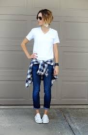 White V Neck T Shirt Is Tucked In Cuffed Blue Jeans Complete This Outfit By Tying Bu Thanksgiving Outfit Women Casual Tshirt Outfits Thanksgiving Outfit Women