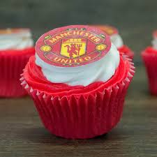 A footy pitch cake with a royal icing man u badge and 12 football player figurines. Football Cupcakes Wenzel S The Bakers