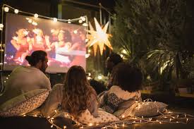I love this luxe outdoor theater decor with blankets, floor pillows, outdoor lounge chairs you could also make a popcorn station with lots of popcorn and a variety of sweet and salty. How To Project A Movie Outside Popsugar Tech