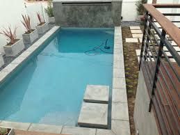 Swimming Pool With Poured In Place Concrete Coping Ipe Wood Deck Pebblecoat Floating Stepping Stones Backyard Pool Swimming Pools Pool