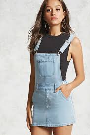 A Denim Overall Dress Featuring A Bib Pocket Slanted Front Pockets Adjustable Shoulder S Denim Dungaree Dress Outfit Denim Overall Dress Denim Dungaree Dress