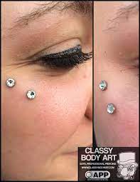 Here Is A Surface Piercing In A Location Sometimes Referred To As An Anti Eyebrow Piercing These Are Not Servi Surface Piercing Cheek Piercings Eye Piercing