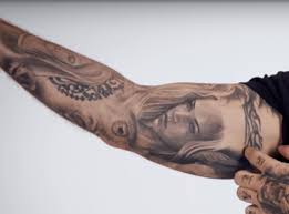 Balvin has got a huge ink on his left bicep. J Balvin Muestra Sus Tatuajes Y Significados Para Gq