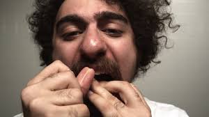 Cu Young Man Looking At Camera And Flossing His Teeth Atlanta Georgia