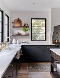 The small round island matches the cabinets throughout the kitchen. Dark Blue Kitchen Cabinets With Light Gray Glazed Brick Tiles Cottage Kitchen