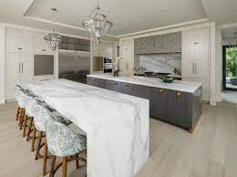 A waterfall counter can be used on a kitchen island, extending the countertop all the way to the floor on each end of the island, so it looks like they are functional too. Modern Residence In Utah Showcases Exquisite Design Features Kitchen Island With Seating Kitchen Layout Contemporary Kitchen