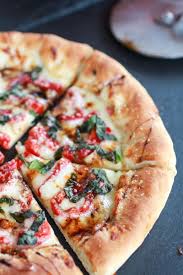 Green Olive Pesto Pizza With Feta Stuffed Crust Roasted Red Peppers And Balsamic Drizzle Half Baked Harvest Recipe Pesto Pizza Stuffed Peppers Olive Pesto