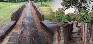 Ancient irrigation canals Polonnaruwa district sluice gates hydraulic engineering 2000 years paddy fields dry zone Sri Lanka motorcycle