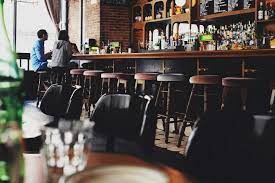 Two Person Sitting On Bar Stool Chair In Front Of Bar Front Desk Photo Free Restaurant Image On Unsplash Bar Restaurant Restaurant Bar