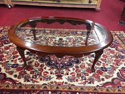 Classic tapered legs and one slightly offset drawer in the apron. Pennsylvania House Glass Top Cherry Coffee Table
