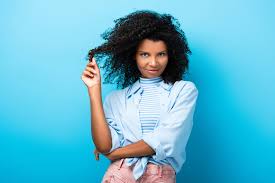Carla was ready to go completely curly! Curly African American Woman Twirling Hair On Finger On Blue Free Stock Photo And Image