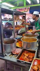 It is a meal of steamed rice that can be plain or mildly flavoured, and served with a variety of curries and side dishes. Gostan Sikit Nasi Kandar Simpang Ampat