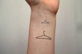 Harry styles' tattoo featuring three large nails is located on the upper part of his left arm, next to his black heart, coathanger and ship artwork. Clothes Hanger Medium Spirit Ink Temporary Tattoo Hanger Tattoo Tattoo Clothing Tattoo Style