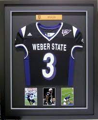 Custom shadow boxes are a specialty of striving artists. Weber State University Football Jersey Framed By Frameworks Of Utah Framed Jersey Football Jersey Frame Football Jersey Display Ideas