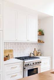 The design of these tiles resemble curved hexagon kitchen wall tiles and has a sophisticated charm that matches the wooden countertops and white cabinetry. 170 White Kitchen Tile Ideas In 2021 White Kitchen Tiles Tile Trends Kitchen