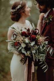 In the autumn there are plenty of gorgeous flowers and foliages to choose from for your wedding flowers. Bouquet Flowers Bride Bridal Burgundy Greenery Foliage Dahlia Astilbe Fern Ribbons Autumn Dark Red Wedding Flowers Spring Wedding Bouquets Red Bouquet Wedding