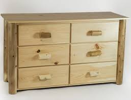 Create an inviting and functional bedroom retreat with this dresser featuring reclaimed pine with a corsican grey finish accented with brass knobs. Rustic Pine Wood And Cedar Log Six Drawer Dresser