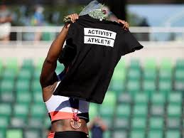 Gwen berry — who qualified for her second us olympic team during the trials — shifted to face the stands rather than the flag before holding up a black shirt that reads activist athlete. M0 L6r Oxbmsvm
