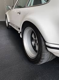 Each tile is 12 x 12 inches and is about half an inch. Motofloor Modular Self Draining Garage Floor Tiles